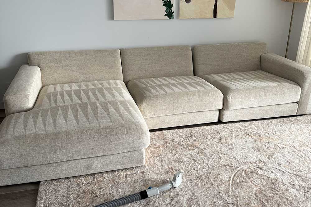Clean beige modular lounge and rug in a family living room after natural-product cleaning